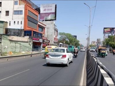 Strategic Hoarding Advertising companies in Lucknow | ACME Advertising Co. High-visibility hoarding on a busy road in Lucknow installed by ACME Advertising Co., a trusted leader in hoarding advertising companies in Lucknow.