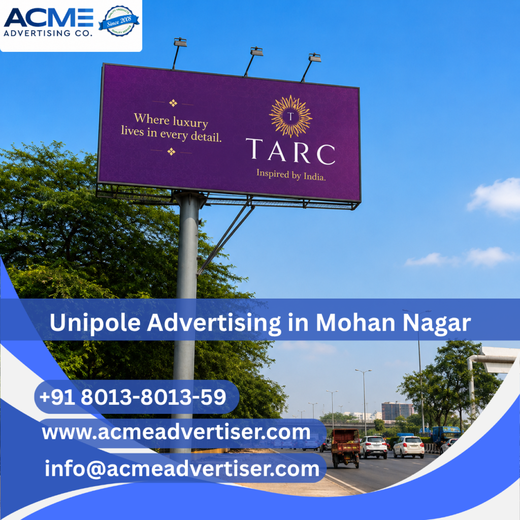 High-visibility unipole advertising display by ACME Advertising Co. from Mohan Nagar to UP Gate at a busy roadside location.