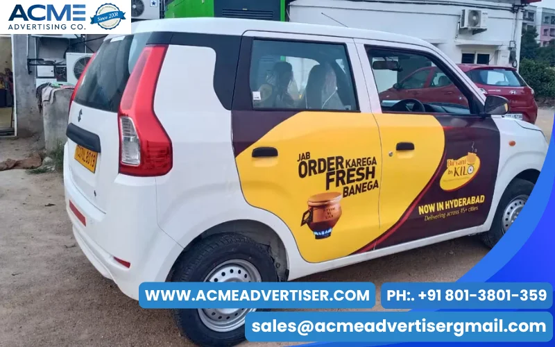 Alt Text: Branded taxi cab moving through a busy urban city road promoting business services through cab branding advertising campaigns.